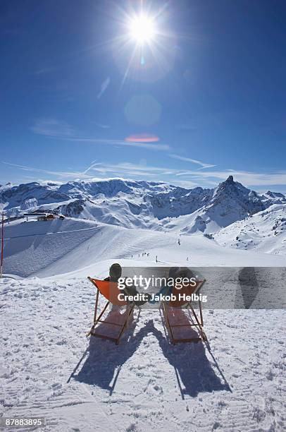 couple reclining in deck chairs - courchevel stockfoto's en -beelden
