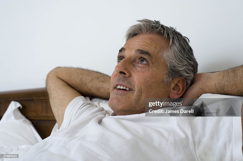 Man with hands behind head