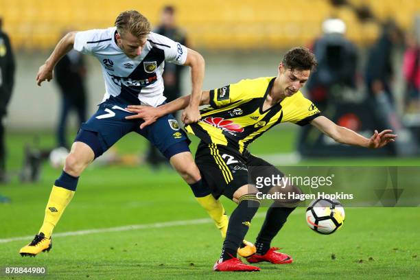 Matthew Ridenton of the Phoenix is tackled by Andrew Hoole of the Mariners during the round eight A-League match between the Wellington Phoenix and...