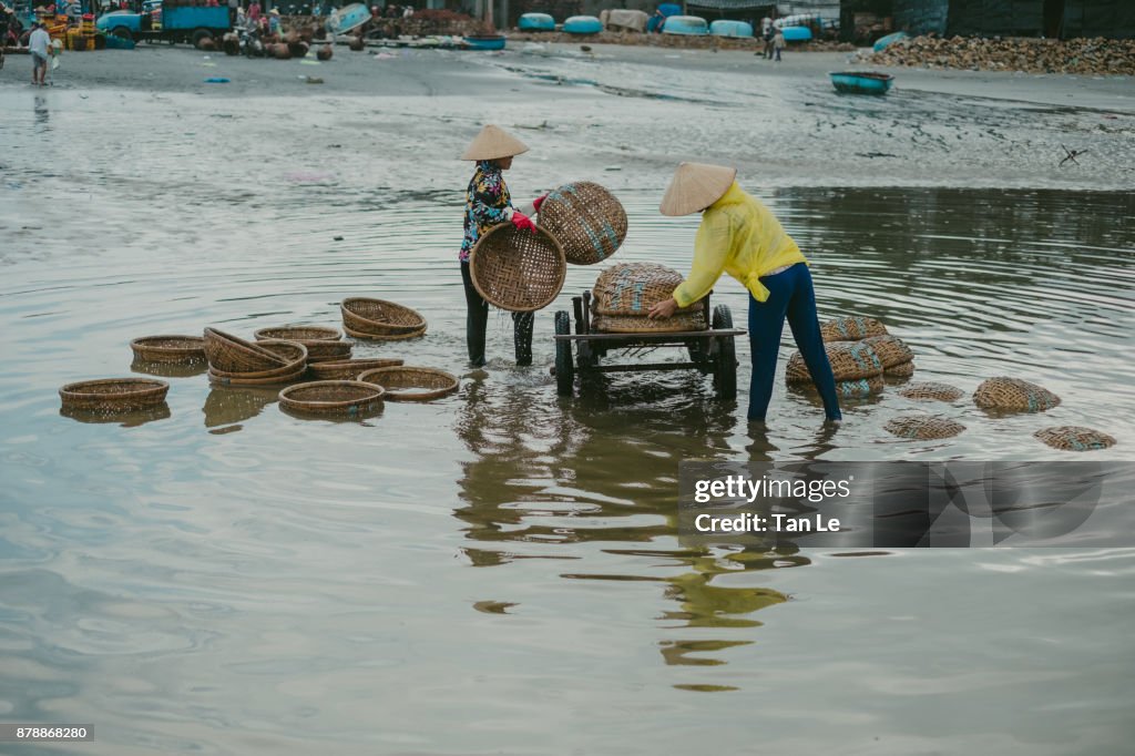 Women are washing bamboo basketry.