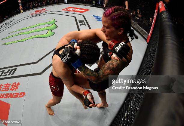 Gina Mazany knees Wu Yanan of China in their women's bantamweight bout during the UFC Fight Night event inside the Mercedes-Benz Arena on November...