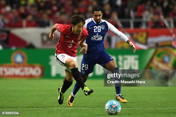 Tomoya Ugajin of Urawa Red Diamonds and Salem Al Dawsari of Al-Hilal compete for the ball during the AFC Champions League Final second leg match...