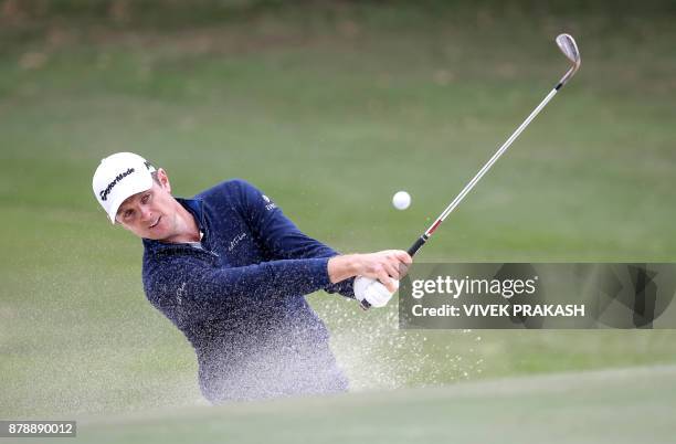 Justin Rose of England hits a shot out of the bunker during round three of the Hong Kong Open tournament at the Hong Kong Golf Club on November 25,...