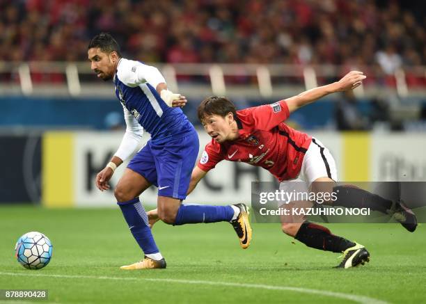 Al Hilal's midfielder Salem al-Dawsari runs past Urawa Red Diamonds' midfielder Tomoya Ugajin during the second leg of the AFC Champions League...