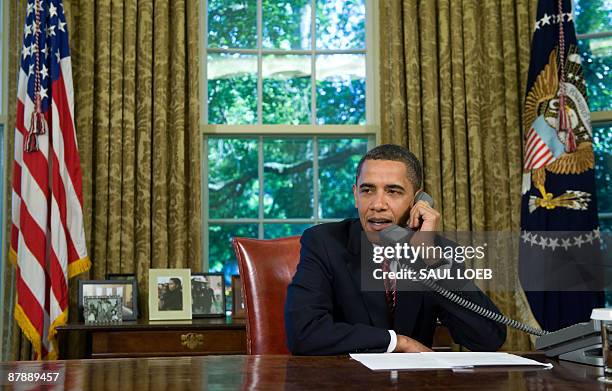 President Barack Obama talks on the phone with Astronauts aboard the Space Shuttle Atlantis, while on a mission to repair the Hubble Space Telescope,...