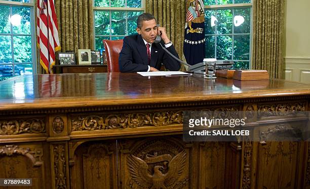 President Barack Obama talks on the phone with Astronauts aboard the Space Shuttle Atlantis, while on a mission to repair the Hubble Space Telescope,...