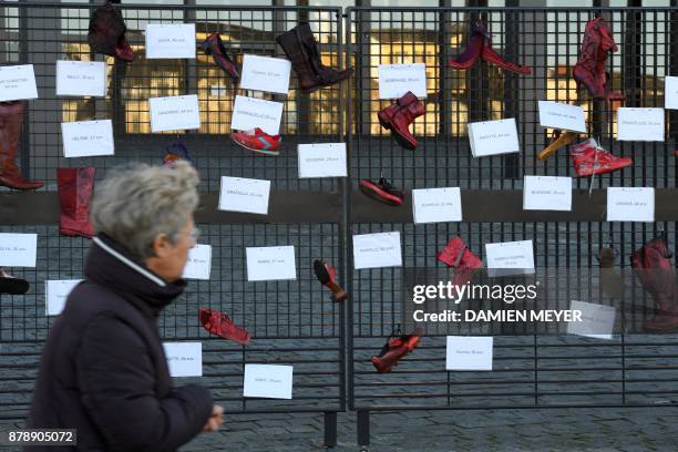 Picture taken on November 25, 2017 near the courthouse of Nantes shows red-painted shoes symbolizing women victims of domestic violence, harassment,...