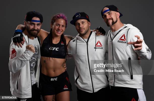 Gina Mazany poses for a portrait backstage with her team after her victory over Wu Yanan of China during the UFC Fight Night event inside the...