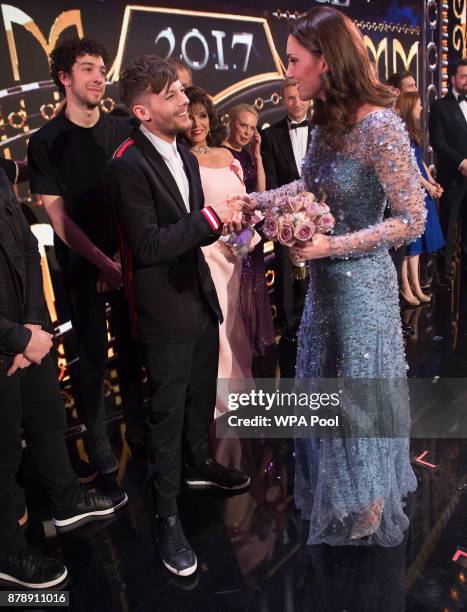 Catherine, Duchess of Cambridge speaks to Louis Tomlinson on stage as they attend the Royal Variety Performance at the Palladium Theatre on November...