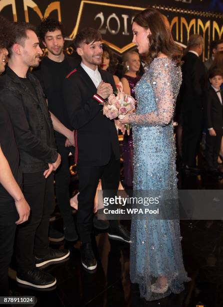 Catherine, Duchess of Cambridge speaks to Louis Tomlinson and performers on stage as they attend the Royal Variety Performance at the Palladium...