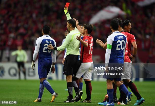 Salem Al Dawsari of Al-Hilal is shown a red card by referee Ravshan Irmatov during the AFC Champions League Final second leg match between Urawa Red...