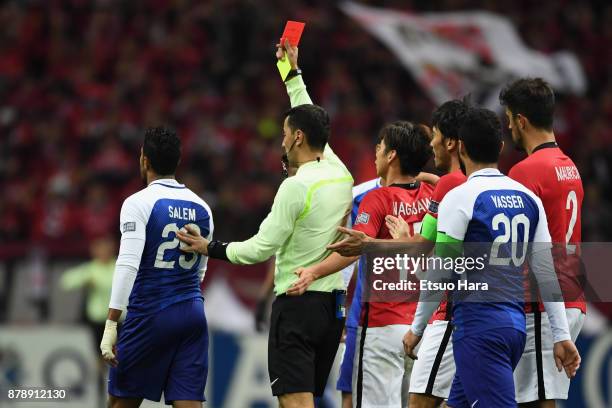 Salem Al Dawsari of Al-Hilal is shown a red card by referee Ravshan Irmatov during the AFC Champions League Final second leg match between Urawa Red...