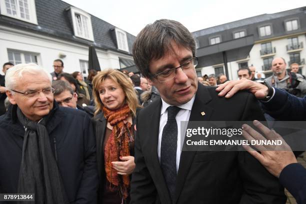 Deposed Catalan leader Carles Puigdemont unites with his fellow candidates after a press conference in Oostkamp, near Brugge, on November 25, 2017...