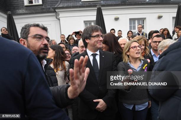 Deposed Catalan leader Carles Puigdemont unites to pose with his fellow candidates after a press conference in Oostkamp, near Brugge, on November 25,...