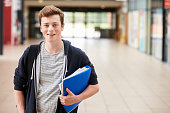Portrait Of Male Student Standing In College Building
