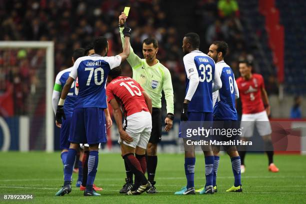 Kazuki Nagasawa of Urawa Red Diamonds is shown a yellow card by referee Ravshan Irmatov during the AFC Champions League Final second leg match...