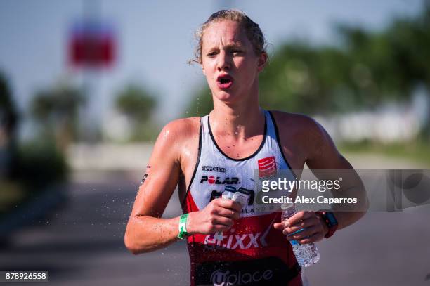 Emma Pallant of Great Britain refreshes during the run leg of IRONMAN 70.3 Middle East Championship Bahrain on November 25, 2017 in Bahrain, Bahrain.