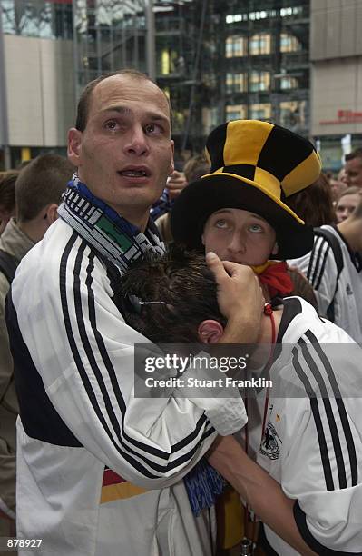 German football fans show their disappointment as there team crash to a 2-0 defeat against Brazil in the World Cup Final in Yokohama, at Potsdam Plaz...