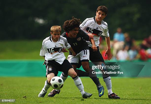 Kevin Holzweier and Timo Cecen of Germany defend as Eric Gonzales of the U.S.A. Attacks during a friendly match between Germany and U.S.A. At the...