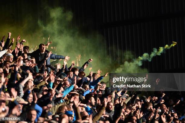 Smoke canister is thrown as Leeds United fans celebrate during the Sky Bet Championship match between Barnsley and Leeds United at Oakwell Stadium on...