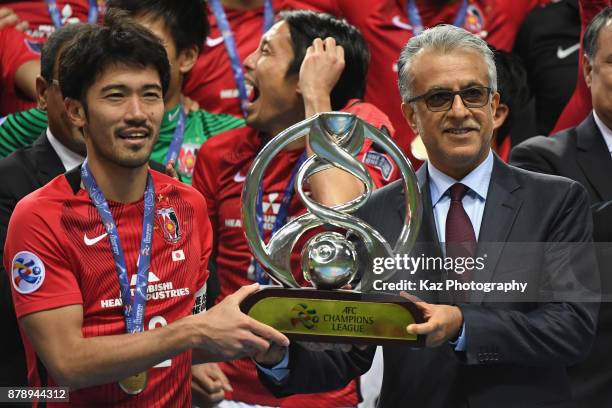 Captain Yuki Abe of Urawa Red Diamonds receives the AFC Champions League Trophy by the Asian Football Confederation President Shaikh Salman bin...