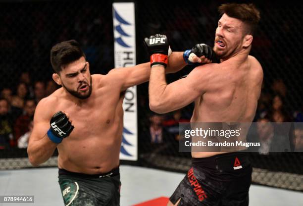 Kelvin Gastelum punches Michael Bisping of England in their middleweight bout during the UFC Fight Night event inside the Mercedes-Benz Arena on...