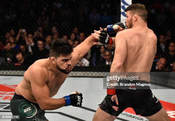 Kelvin Gastelum punches Michael Bisping of England in their middleweight bout during the UFC Fight Night event inside the Mercedes-Benz Arena on...