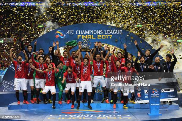 Captain Yuki Abe of Urawa Red Diamonds lifts the AFC Champions League trophy at the award ceremony during the AFC Champions League Final second leg...