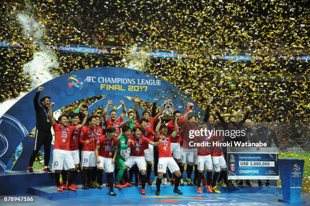 Captain Yuki Abe of Urawa Red Diamonds lifts the AFC Champions League trophy at the award ceremony during the AFC Champions League Final second leg...