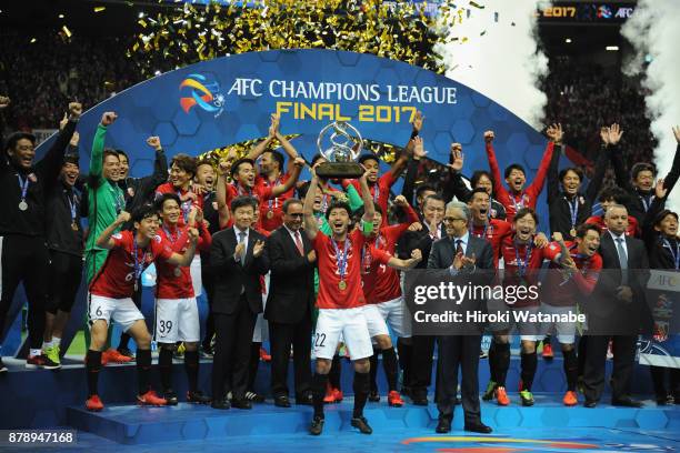 Captain Yuki Abe of Urawa Red Diamonds lifts the AFC Champions League trophy at the award ceremony during the AFC Champions League Final second leg...