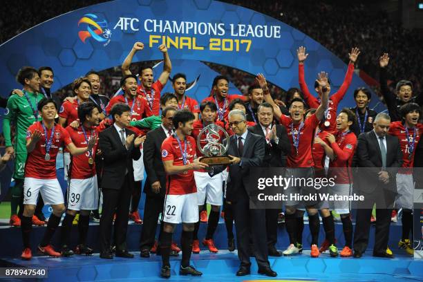 Captain Yuki Abe of Urawa Red Diamonds receives the AFC Champions League Trophy by the Asian Football Confederation President Shaikh Salman bin...