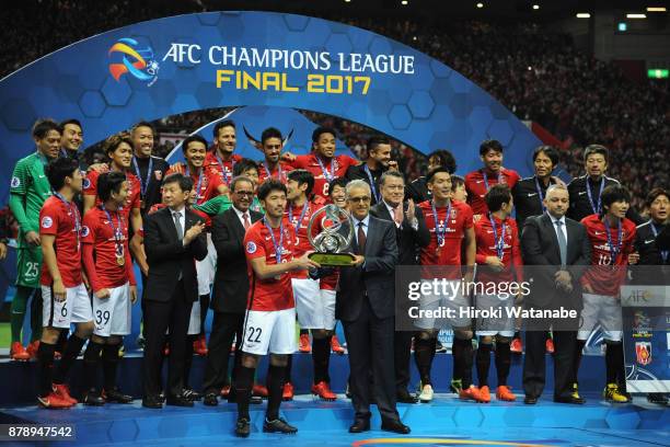 Captain Yuki Abe of Urawa Red Diamonds receives the AFC Champions League Trophy by the Asian Football Confederation President Shaikh Salman bin...