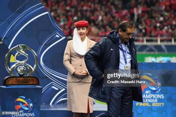 Head coach Ramon Diaz of Al-Hilal walks past the AFC Champions League Trophy at the medal ceremony after the AFC Champions League Final second leg...