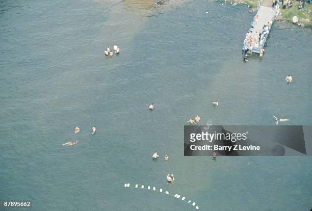 Aerial view of swimmers in the lake on the grounds of the Woodstock Music and Arts Fair in Bethel, New York, August 15 - 17 , 1969.