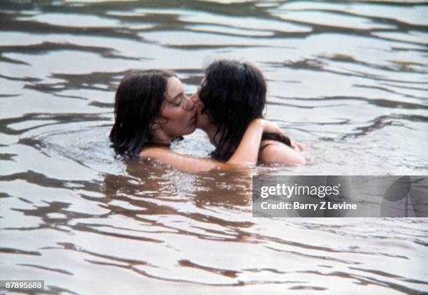 An unidentified couple kiss while mostly submerged under water in a lake on the grounds of the Woodstock Music and Arts Fair in Bethel, New York,...