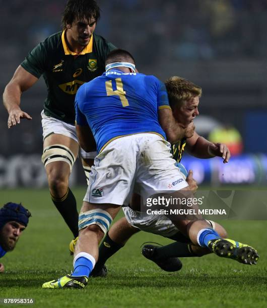 South African flanker Pieter-Steph Du Toit is tackled by Italian second row Marco Fuser during a rugby union Test match between Italy and South...