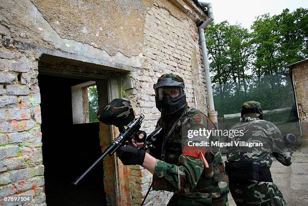 Two man with paintball markers simulate urban warfare at the Gotcha playground on May 21, 2009 in Vysocany, Czech Republic. The German government has...