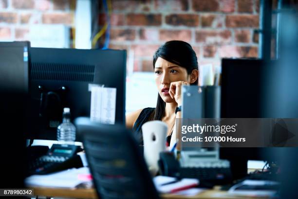 woman working in modern office - indecision stock-fotos und bilder