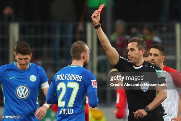 Maximilian Arnold of Wolfsburg sees a red card by referee Tobias Stieler during the Bundesliga match between FC Augsburg and VfL Wolfsburg at...