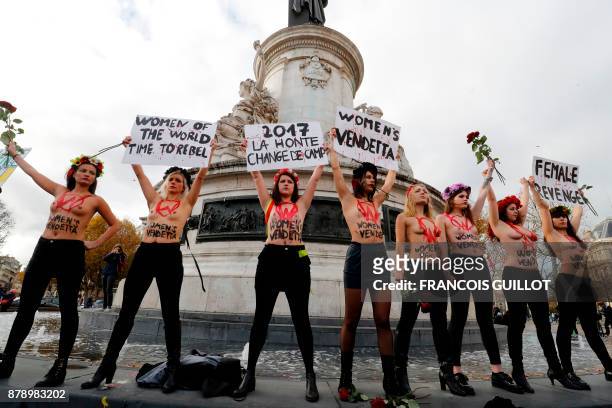 Activists from women's rights movement Femen, including leader Inna Shevchenko , stand topless while holding signs on the Place de la Republic in...
