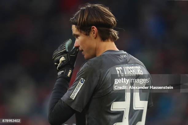 Marwin Hitz of Augsburg looks dejected after he wasn't able to save a goal against Wolfsburg to make it 1:0 during the Bundesliga match between FC...