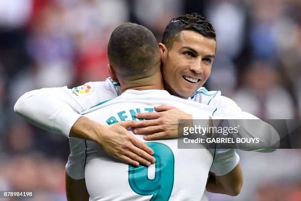 Real Madrid's French forward Karim Benzema celebrates with Real Madrid's Portuguese forward Cristiano Ronaldo after scoring during the Spanish league...