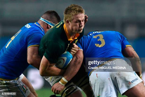 South African scrum-half Ross Cronje is tackled by Italian second row Marco Fuser and Italiann tighthead prop Simone Ferrari during a Rugby union...