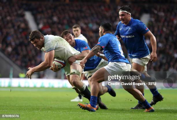 Charlie Ewels of England touches downn for the third try while being tackled by Dwayne Polataivao of Samoa during the Old Mutual Wealth Series match...