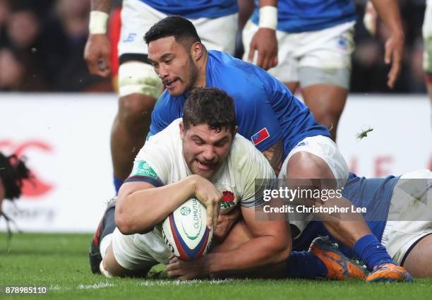 Charlie Ewels of England touches downn for the third try while being tackled by Dwayne Polataivao of Samoa during the Old Mutual Wealth Series match...