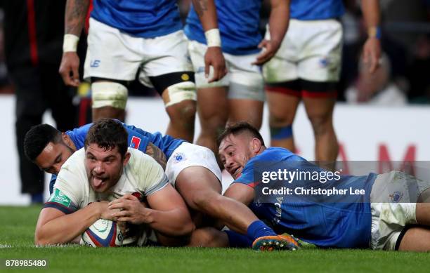 Charlie Ewels of England touches downn for the third try while being tackled by Dwayne Polataivao of Samoa during the Old Mutual Wealth Series match...