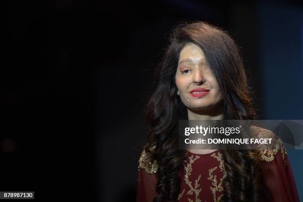 Indian acid attack survivor and model Reshma Qureshi presents a creation by designer Archana Kocharat during a fashion show organised by the "Make...