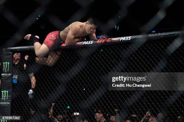 Li Jingliang climbs after his fight with Zak Ottow during the UFC Fight Night at Mercedes-Benz Arena on November 25, 2017 in Shanghai, China.