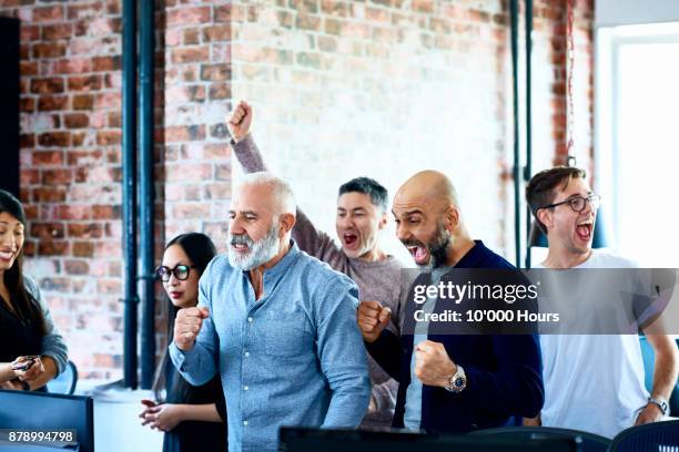 people cheering in modern office - winning celebration stock pictures, royalty-free photos & images
