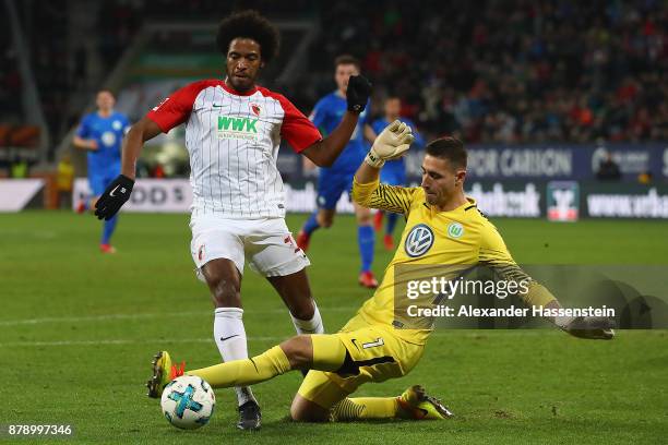 Caiuby of Augsburg is fouled by Koen Casteels of Wolfsburg during the Bundesliga match between FC Augsburg and VfL Wolfsburg at WWK-Arena on November...